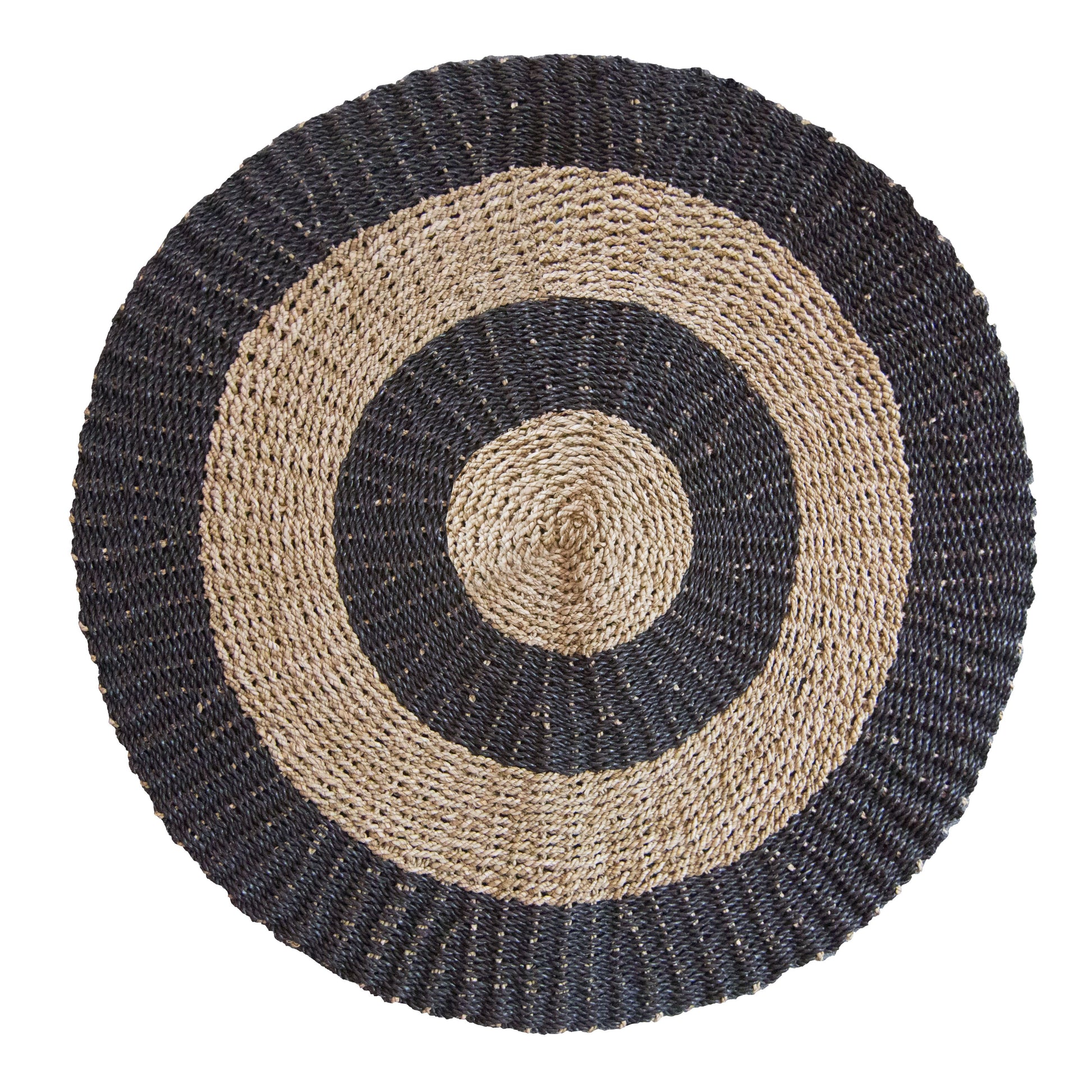 A round 1 metre seagrass rug featuring a natural tan base with a decorative black circular pattern.