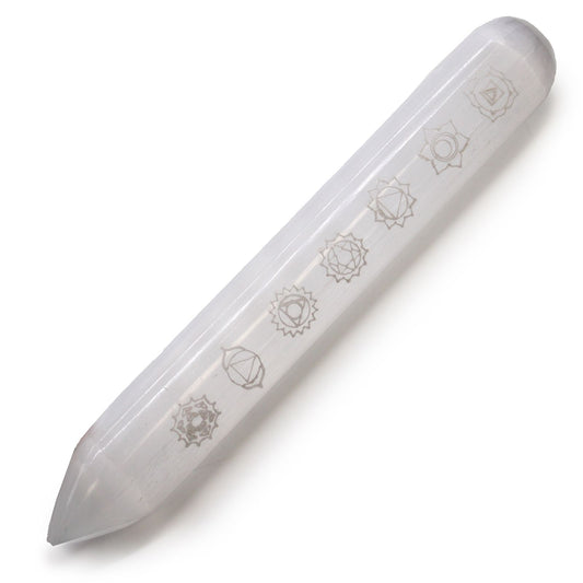White selenite wand with seven colourful chakra stones and a pointed end on a neutral background.