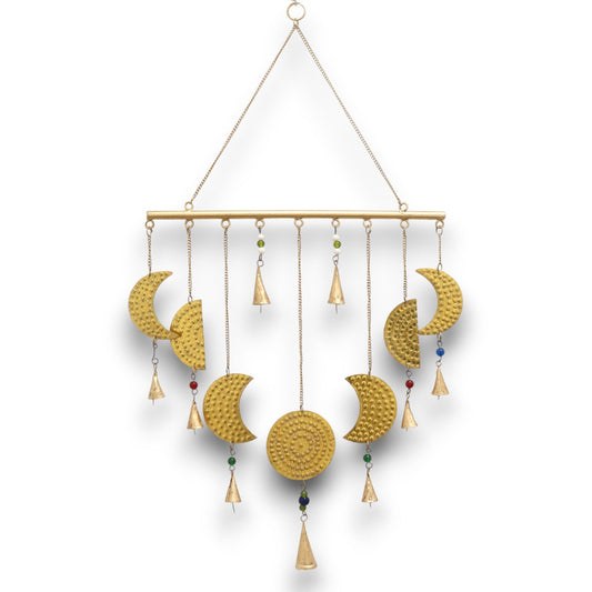 Intricate brass wall hanging depicting the phases of the moon with small decorative bells.