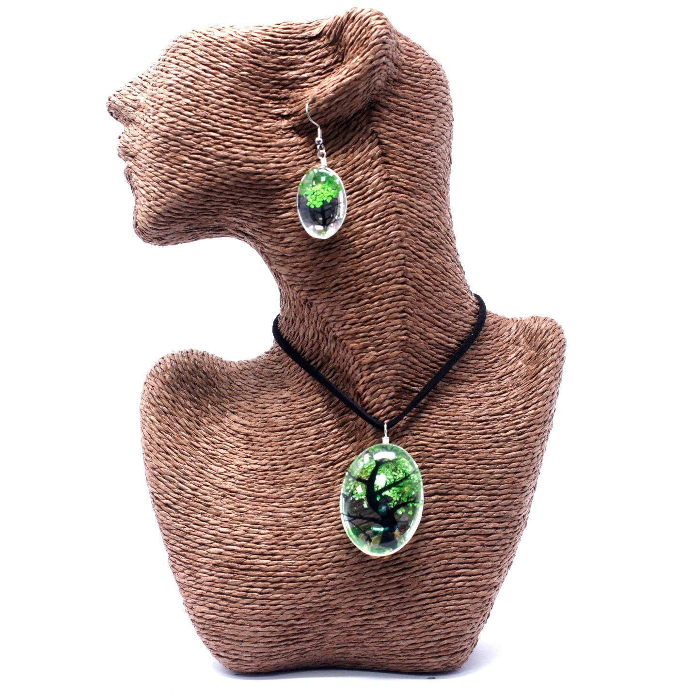 Intricate Tree of Life pendant and earring set featuring real green pressed flowers encased in clear glass.