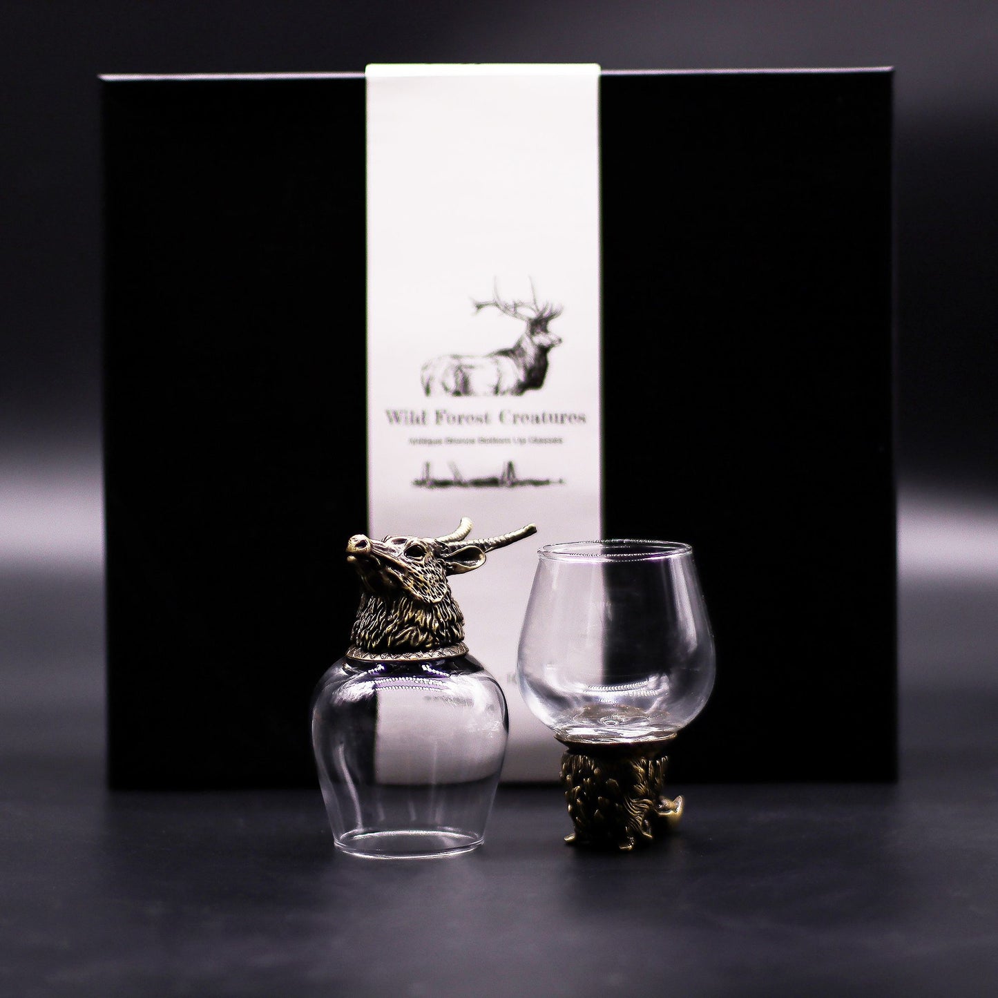 Clear 100ml glasses set on ornate antique bronze metal bases featuring detailed wild forest creature designs.