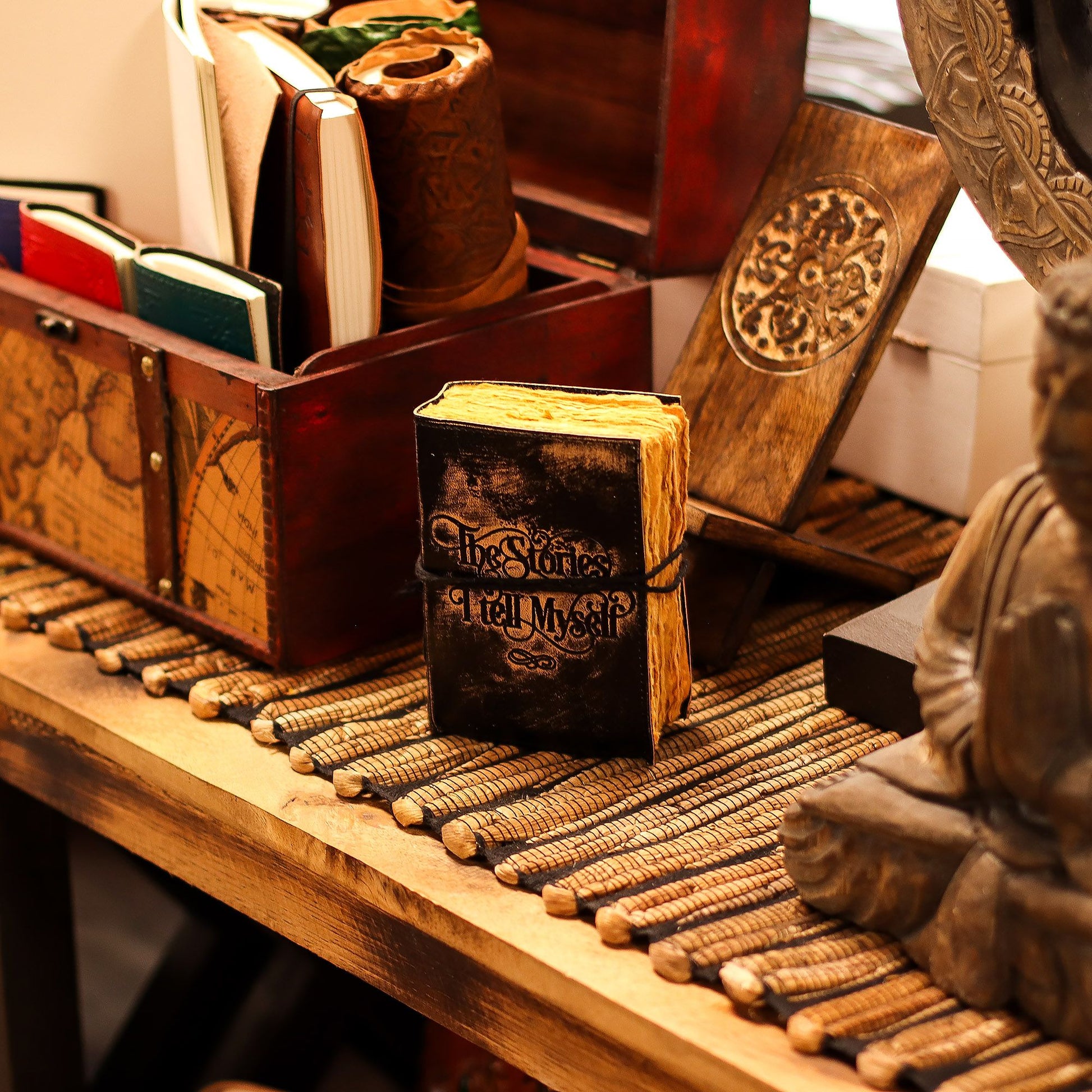 Small black embossed leather notebook with thick handcrafted deckled-edge paper and a vintage distressed finish.