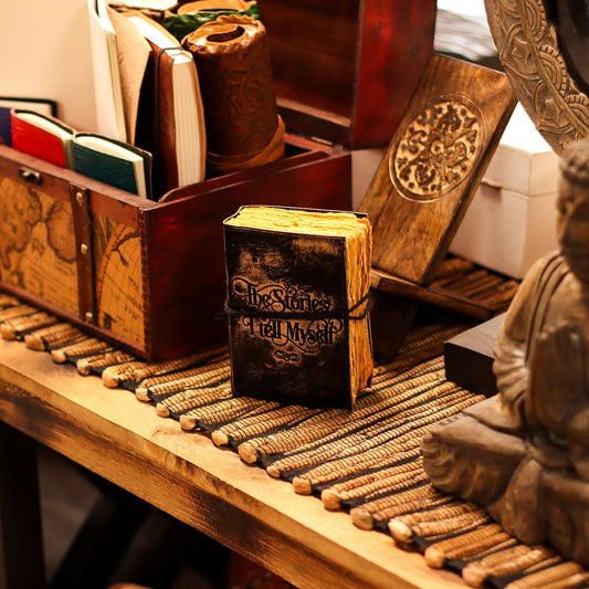 Small black embossed leather notebook with thick handcrafted deckled-edge paper and a vintage distressed finish.
