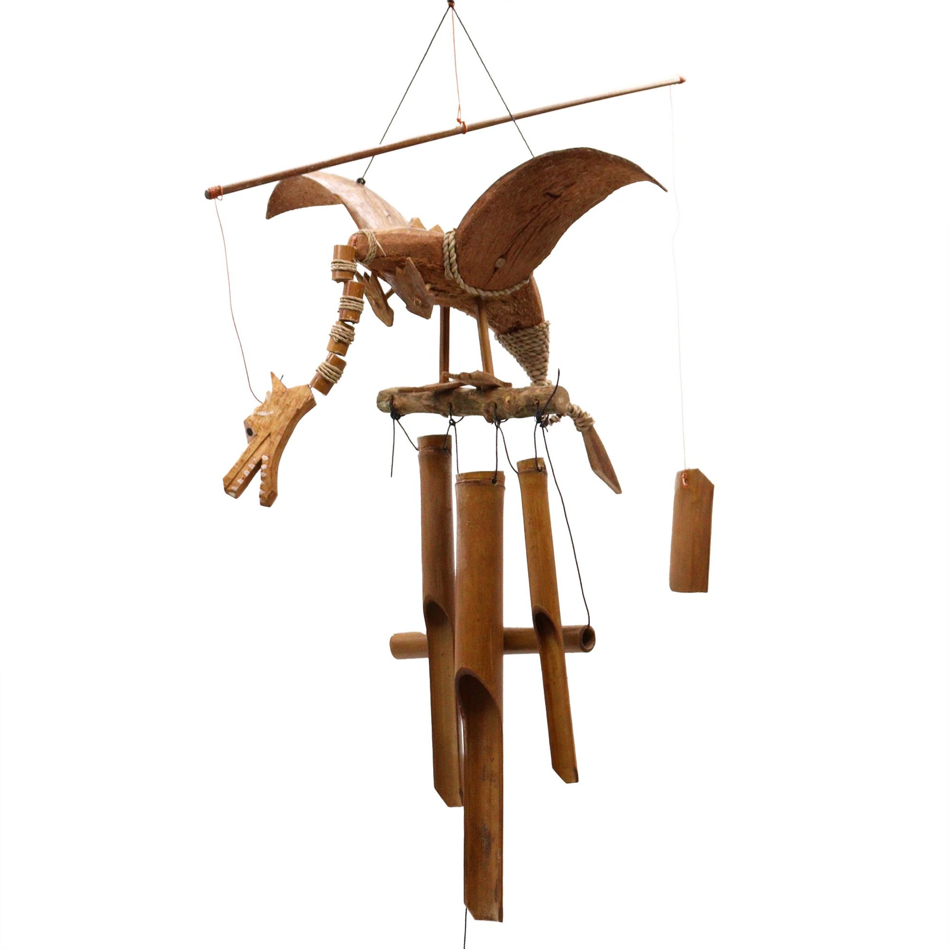 Handcrafted dragon wind chime made from coconut shells with large wings hanging from a hook.