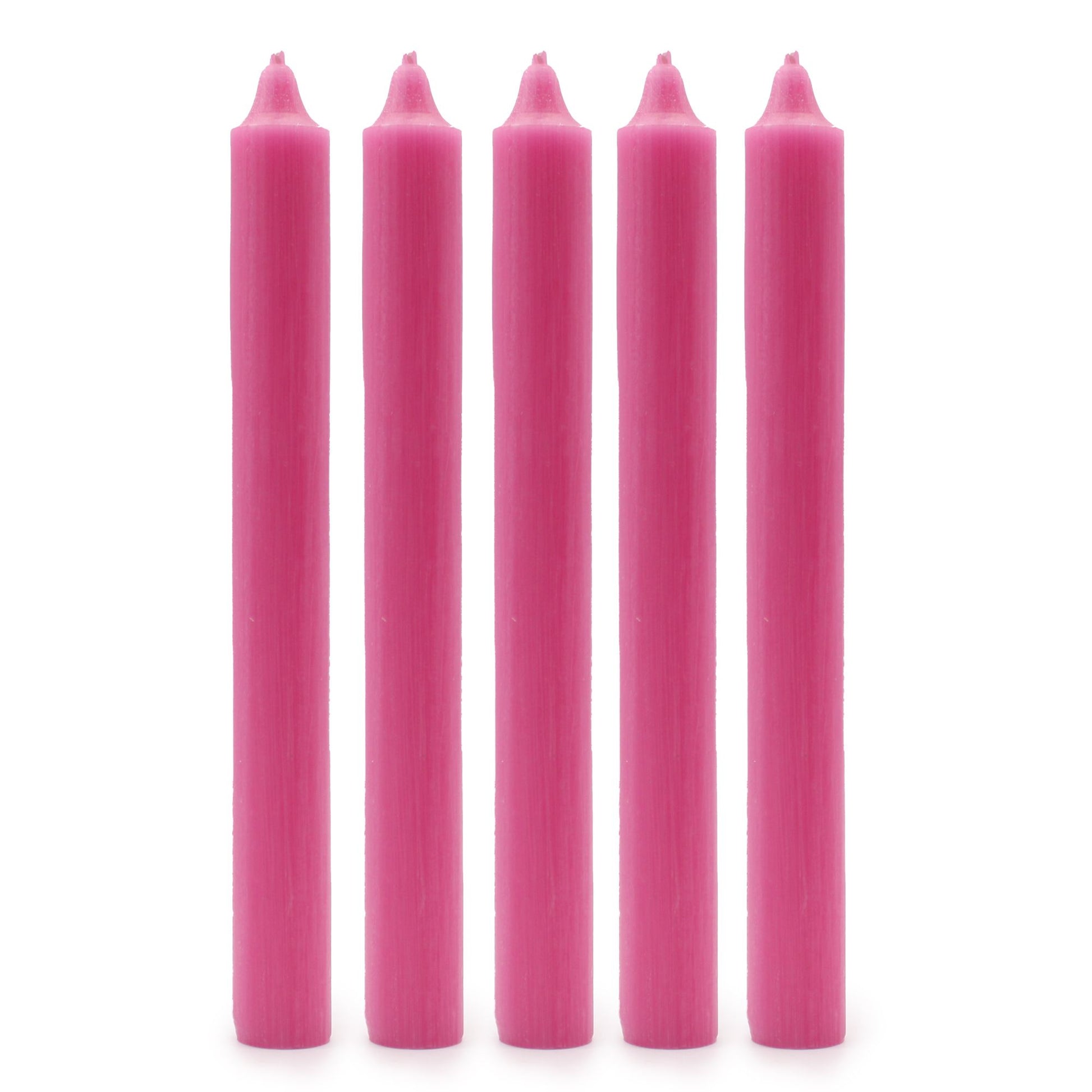 Five tall hand-drawn dinner candles in a rustic deep pink shade arranged together.