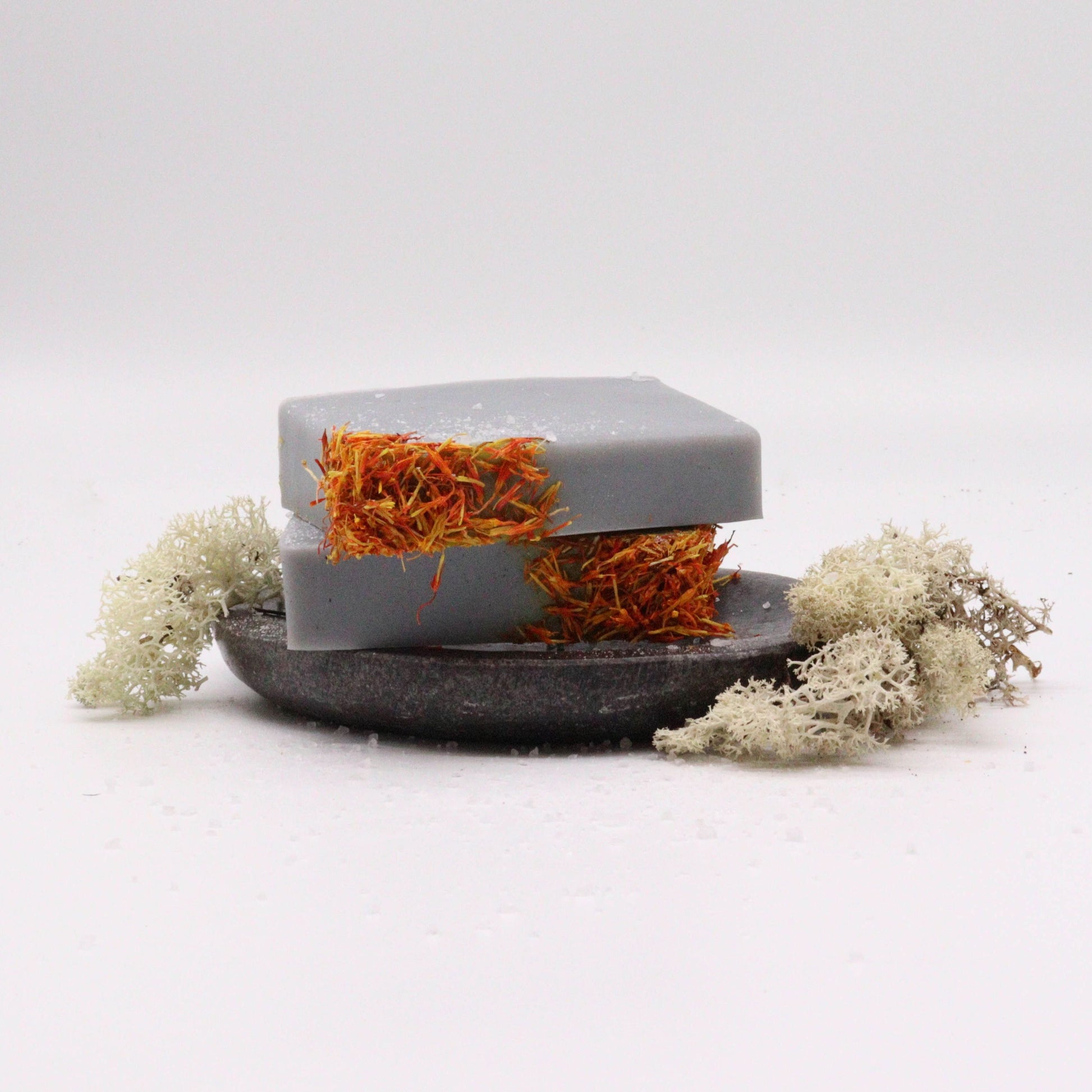 Hand-crafted soap bar with a natural textured surface in earthy coastal tones.