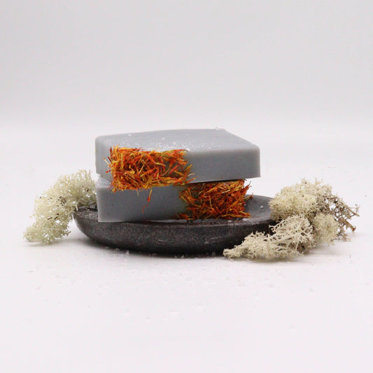 Hand-crafted soap bar with a natural textured surface in earthy coastal tones.
