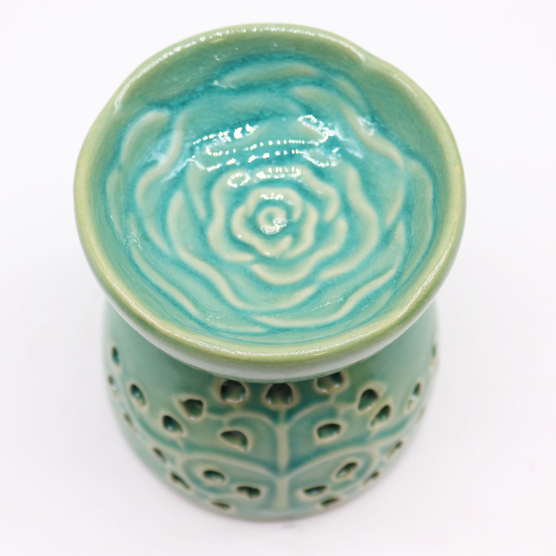 Ceramic oil burner in vibrant blue with a decorative Tree of Life cutout design and glossy finish.
