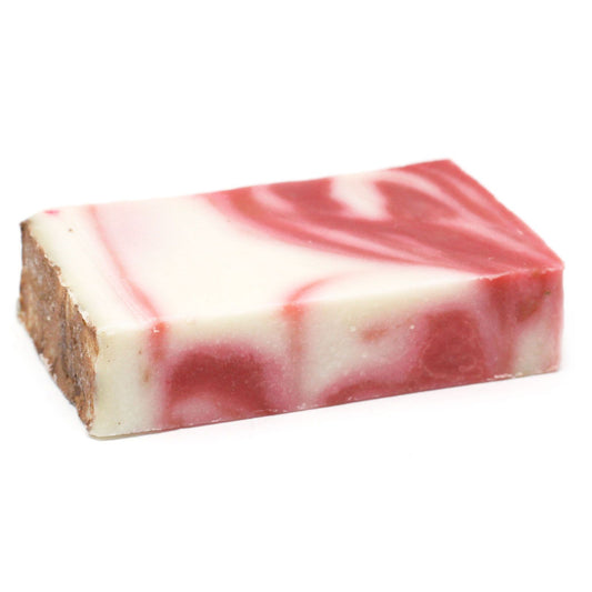 Handcrafted slice of red clay olive oil soap with a rich earthy tone and natural textured finish.