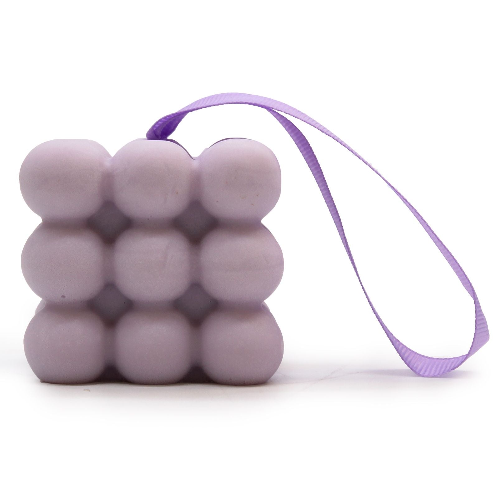 Nubbly textured purple massage soap bar with floral lavender and lilac scent, presented in a decorative box with ribbon.