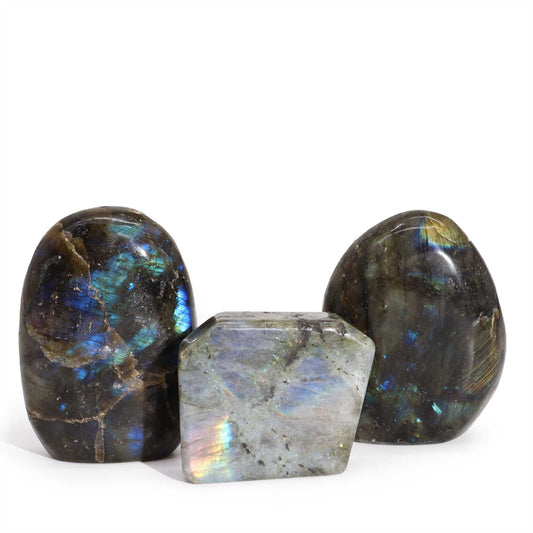 Smooth, polished Madagascar labradorite tomb stone showing a vibrant iridescent blue and green flash.