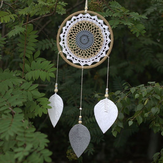 Large brown woven dream catcher with a natural, feather-free design and intricate webbing.