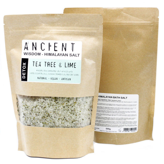 Pink Himalayan bath salts mixed with dried green herbs and essential oils in a clear 500g bag.