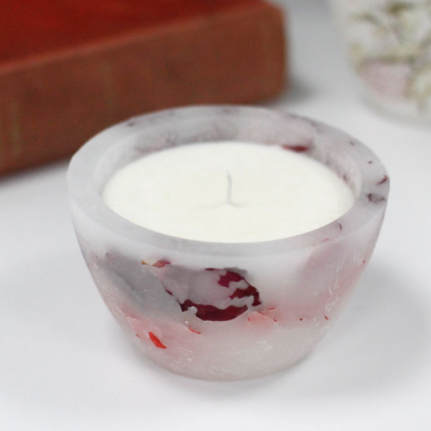 Large decorative bowl candle with embedded rose petals that glows beautifully when lit.