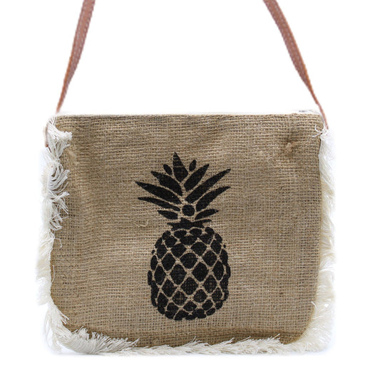 Bohemian style soft washed jute bag featuring a yellow pineapple print and white cotton fringe detailing.