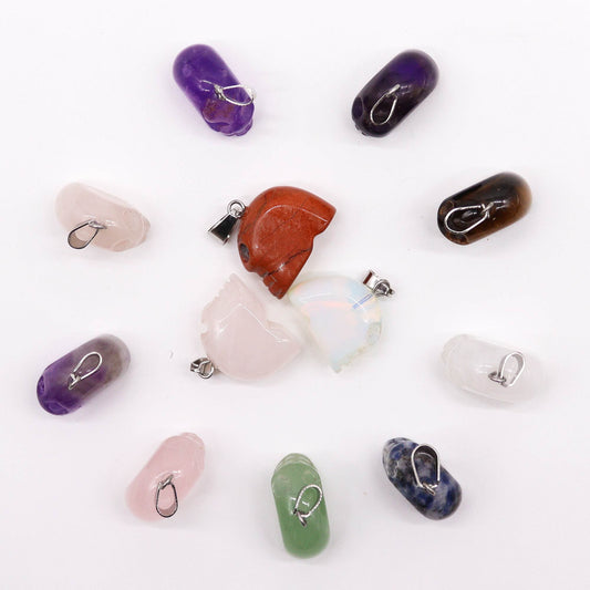 Twelve assorted mini gemstone skull pendants in various natural crystal colours and patterns.