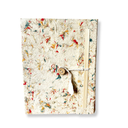 Large handmade notebook with a naturally speckled earthy-toned cover made from recycled cotton and Lokta paper.