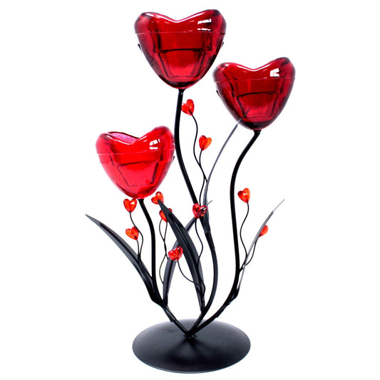 Elegant metal candleholder featuring three heart-shaped flower designs on tall stems for tea lights or small candles.