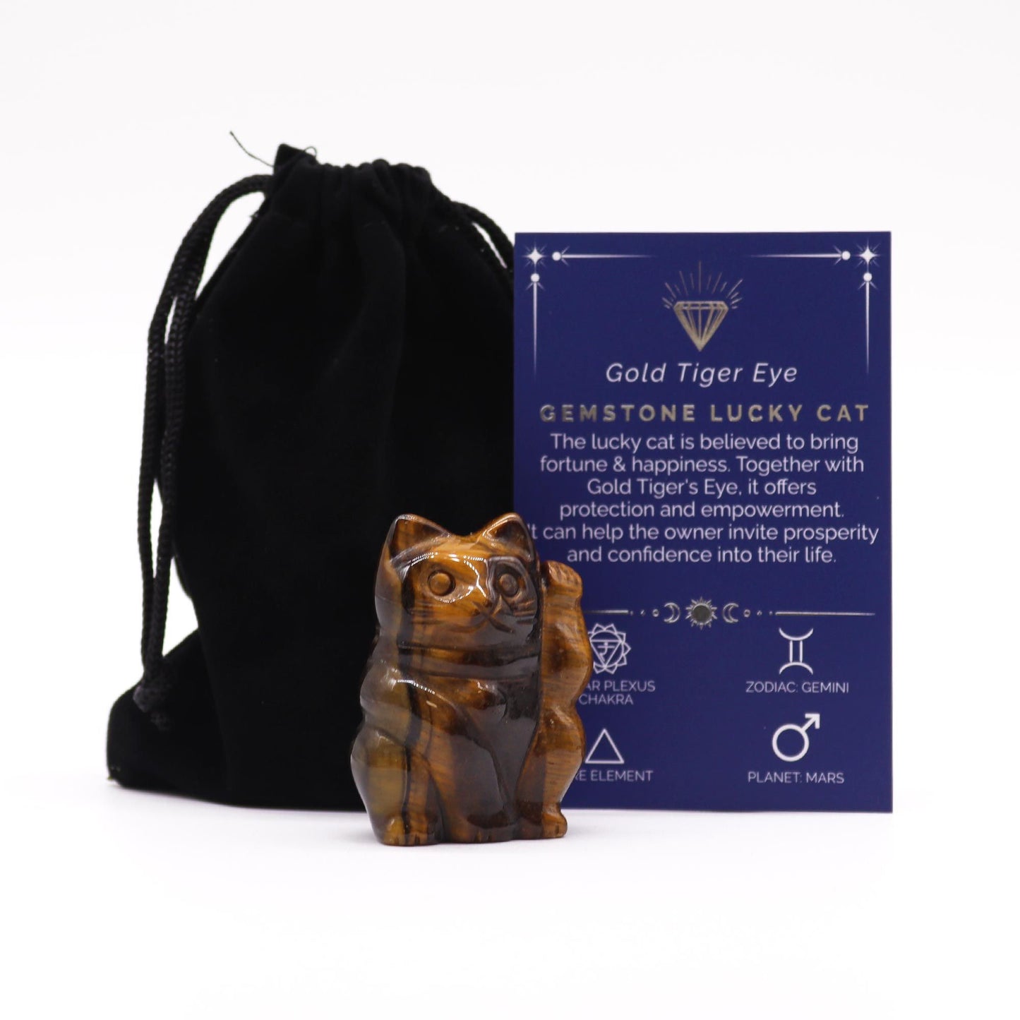 A small hand-carved lucky cat figurine made from shimmering golden-brown tiger eye gemstone with one paw raised.