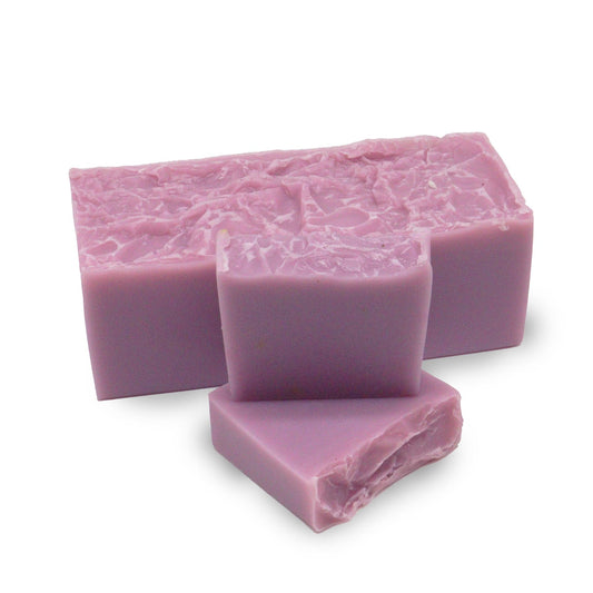 Hand-crafted lavender and coconut soap loaf with a natural, rustic texture and soothing purple and white tones.
