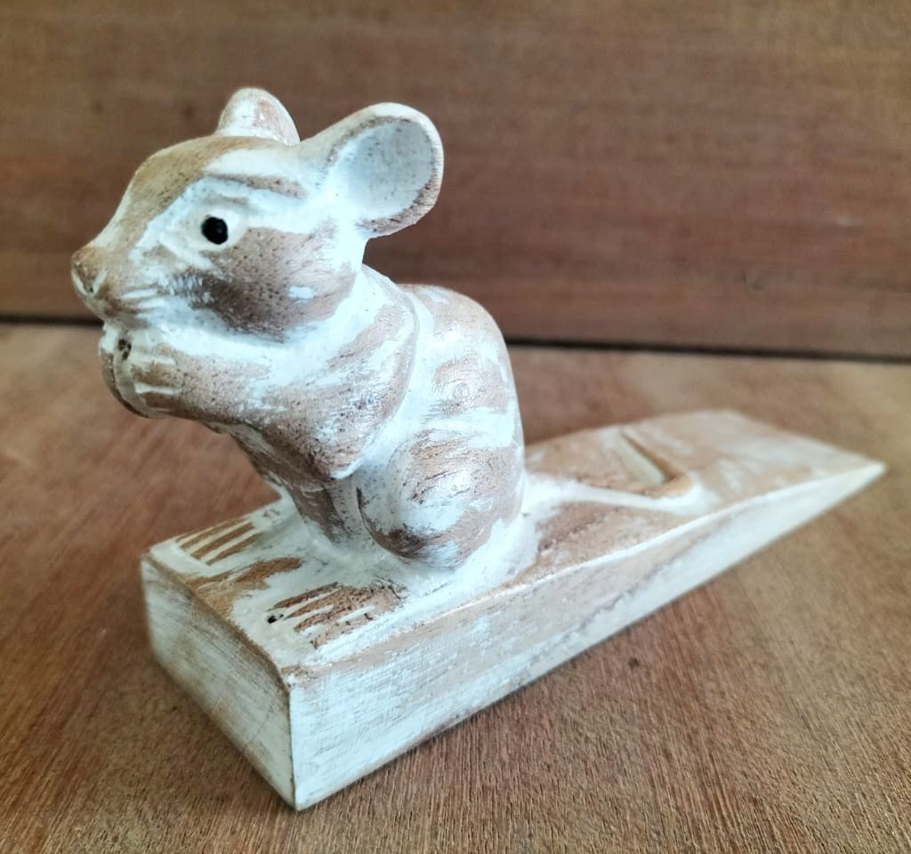 Detailed hand-carved wooden doorstop shaped like a cute dormouse sitting on a wedge base.