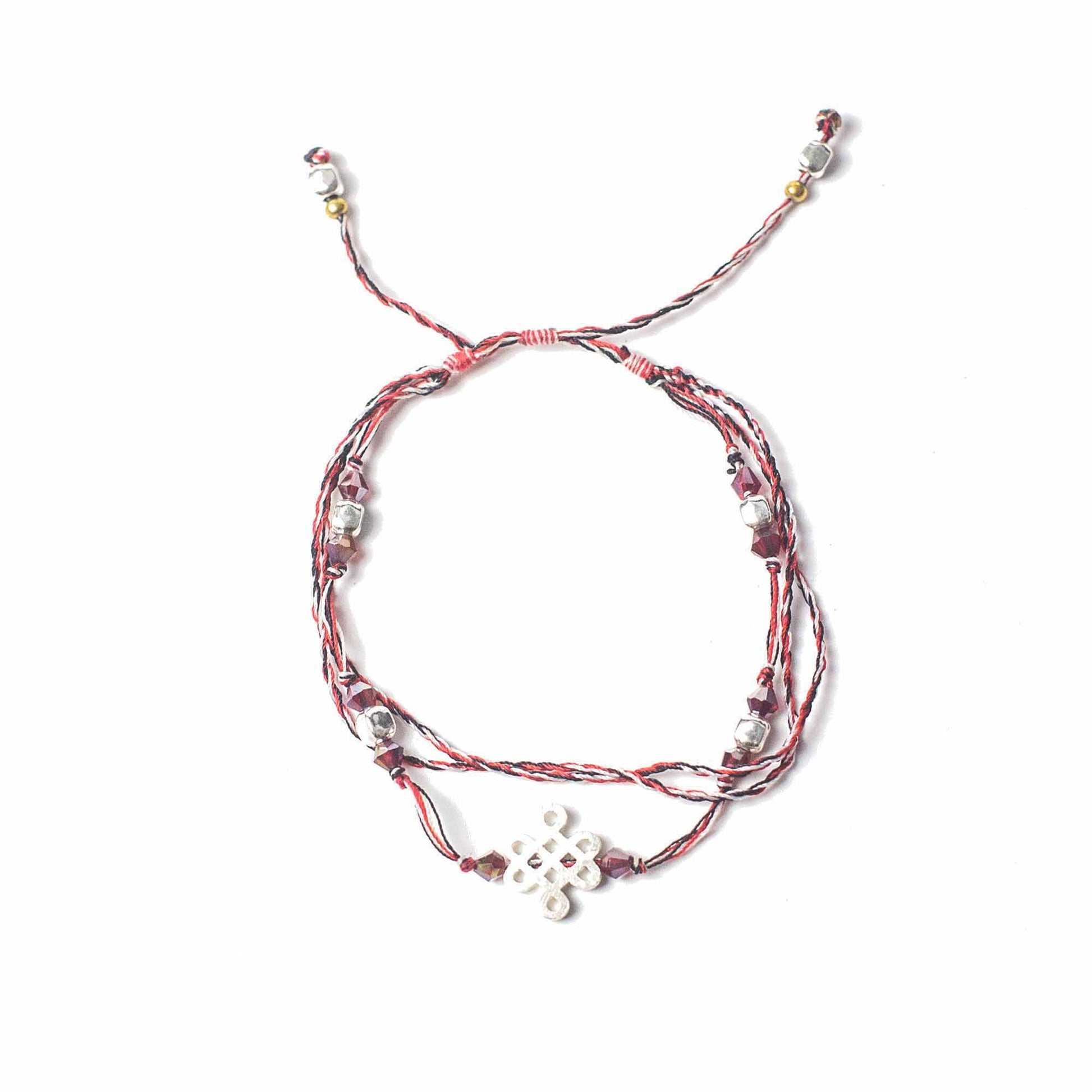 Handcrafted vibrant string bracelet featuring a symbolic silver charm on a woven cord.