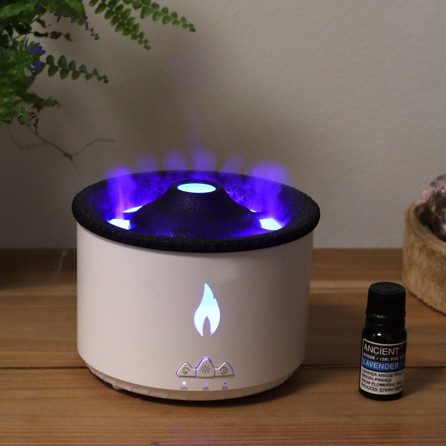 Sleek volcano-inspired aroma diffuser emitting a fine mist with warm ambient lighting in a minimalist setting.
