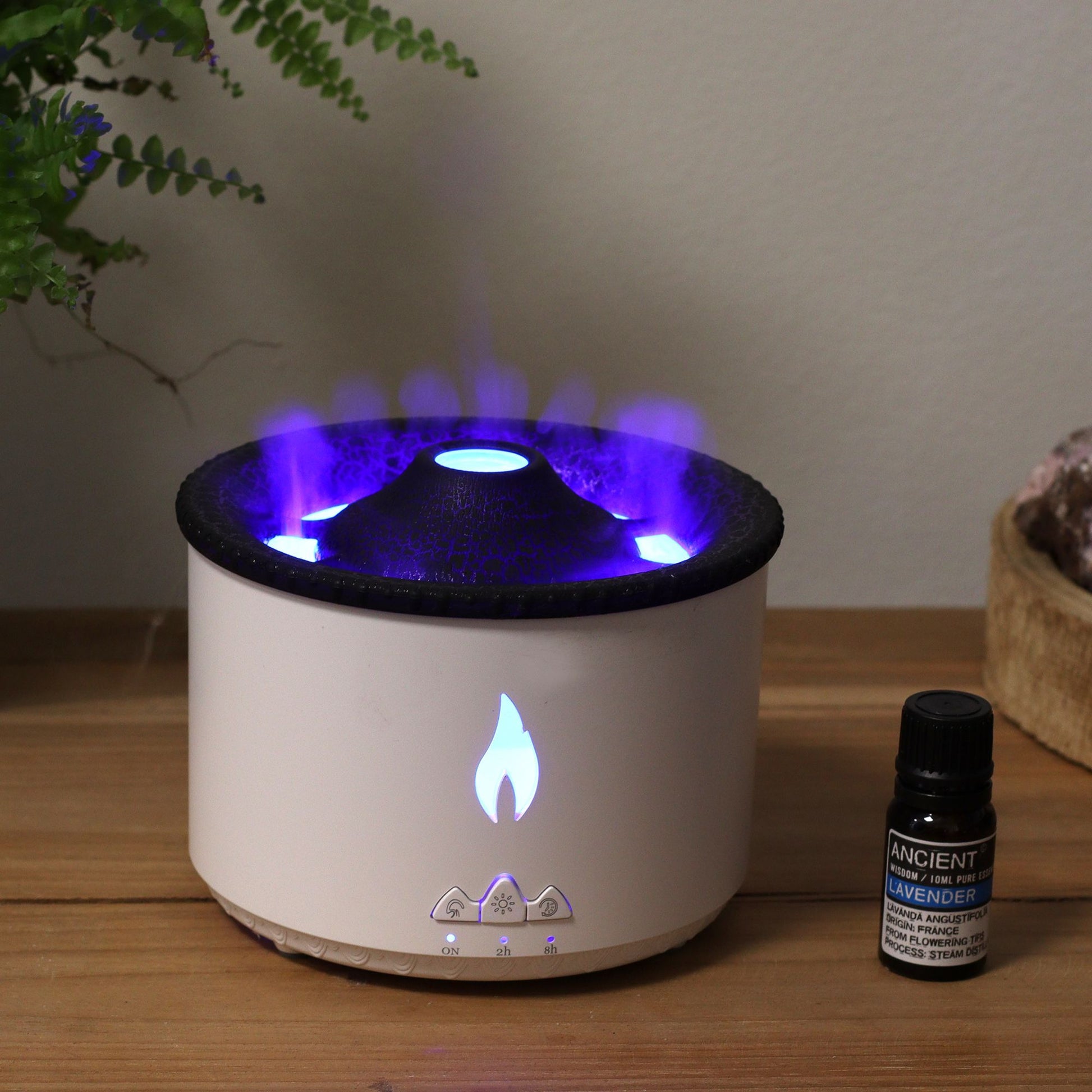Sleek volcano-inspired aroma diffuser emitting a fine mist with warm ambient lighting in a minimalist setting.