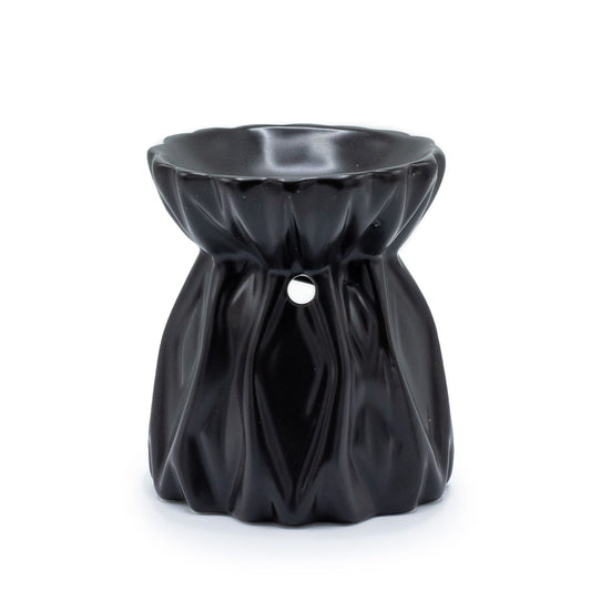 Minimalist black ceramic oil burner with a modern geometric cut-out design and a deep bowl for oils.