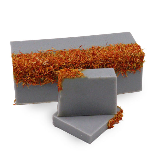 Hand-crafted soap loaf with textured layers and a natural, artisan appearance suggesting a coastal wilderness theme.