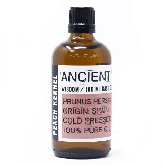 Clear 100ml glass bottle of pale yellow peach kernel oil, a gentle carrier oil for skin and aromatherapy.