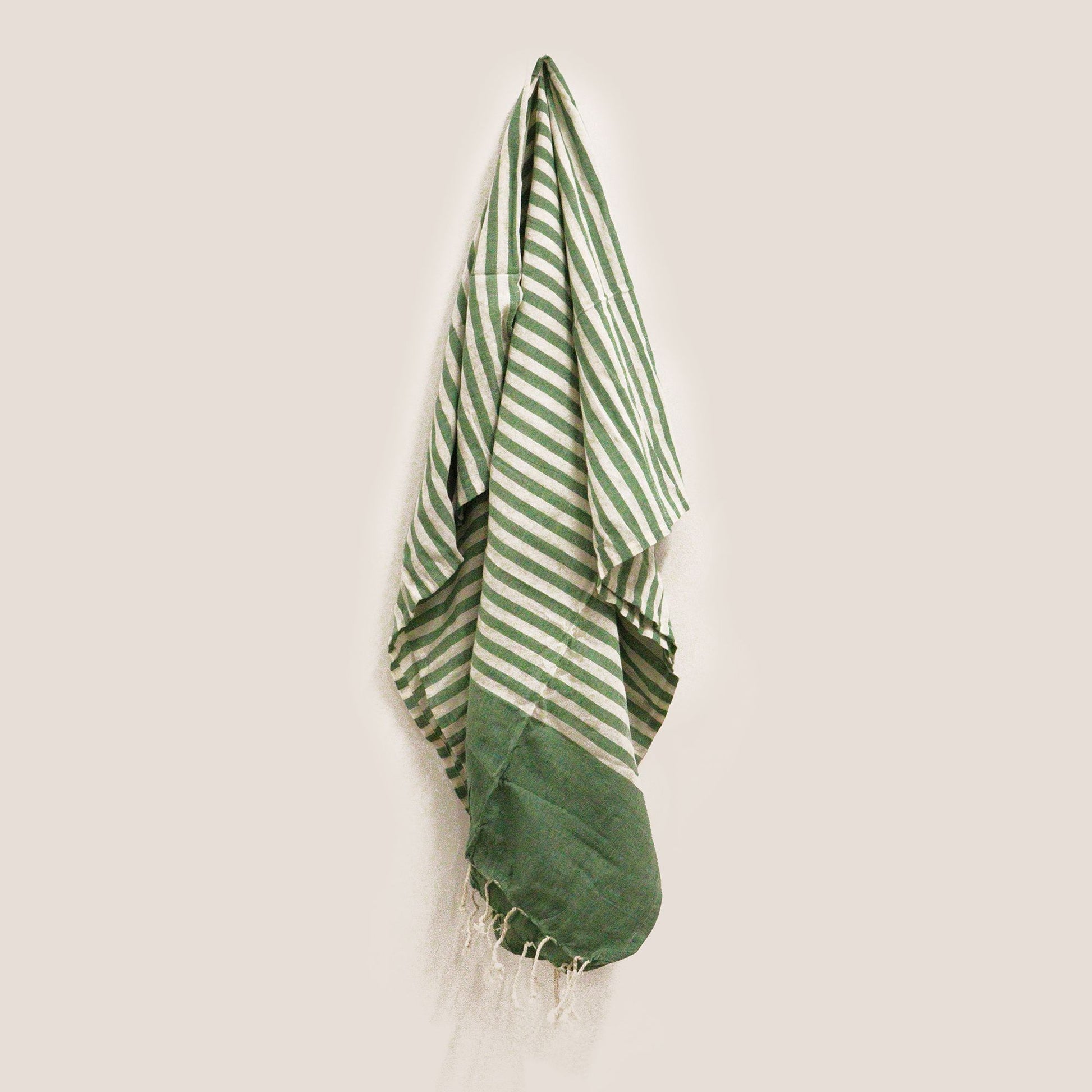 Handcrafted green cotton pareo throw with a traditional weave and soft texture for beach or home use.