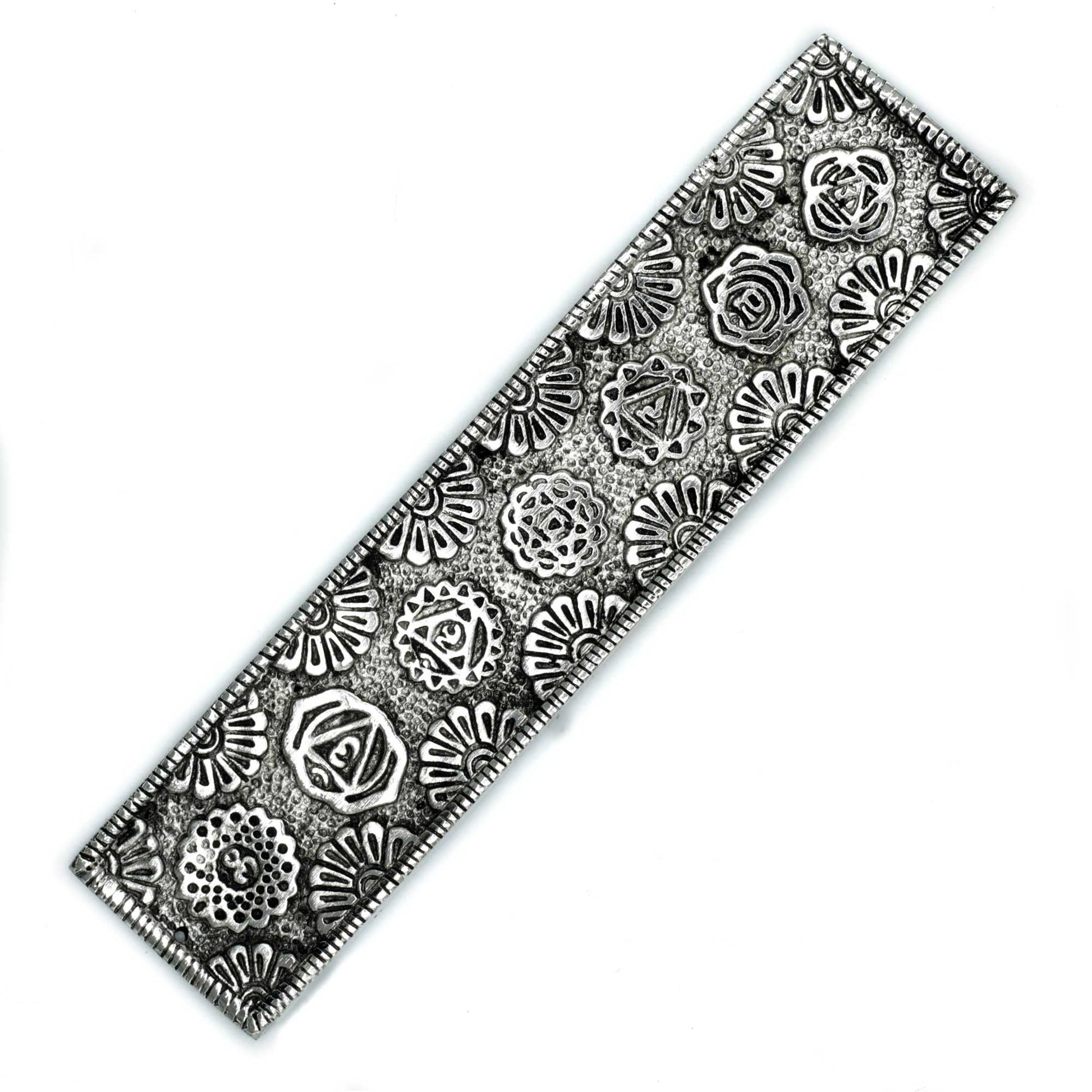 Long, slender polished aluminium incense holder featuring vibrant colourful floral chakra symbols along the body.
