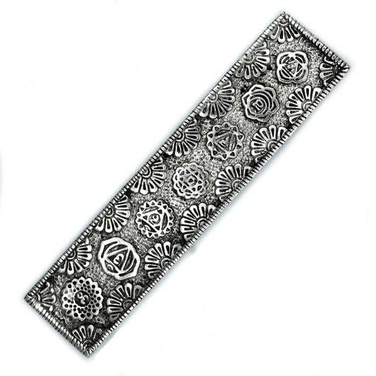 Long, slender polished aluminium incense holder featuring vibrant colourful floral chakra symbols along the body.