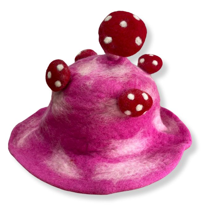 Handcrafted vibrant shocking pink felted wool hat shaped like a mushroom toadstool with white spots.