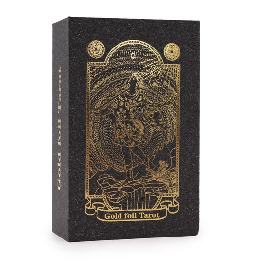 Luxurious gold foil tarot cards with intricate designs displayed alongside a black and gold matching gift box.