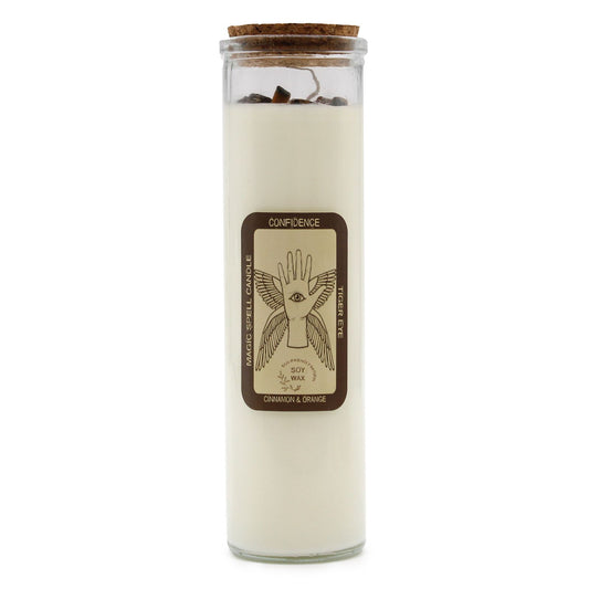 Hand-poured soy wax spell candle topped with brown tiger eye gemstones and aromatic cinnamon pieces in a glass jar.