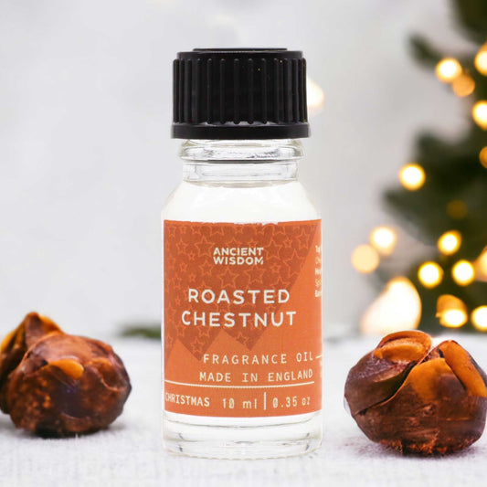 Small amber glass bottle of roasted chestnut fragrance oil with a black dropper cap on a neutral background.