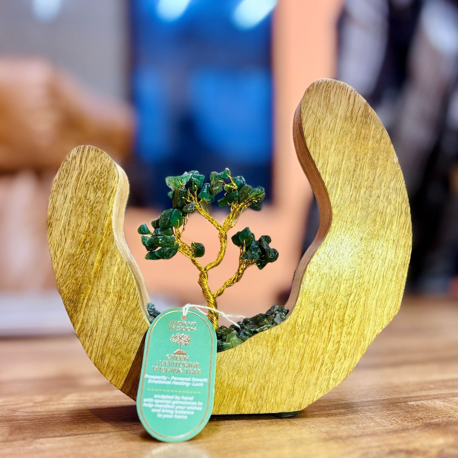 Handcrafted gemstone tree with green aventurine chipstones set within a circular mango wood open ring frame.