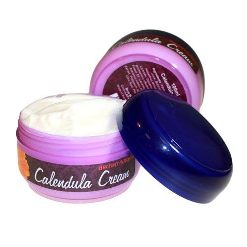 A jar of rich, yellow-tinted herbal calendula cream for soothing skin irritation and dryness.