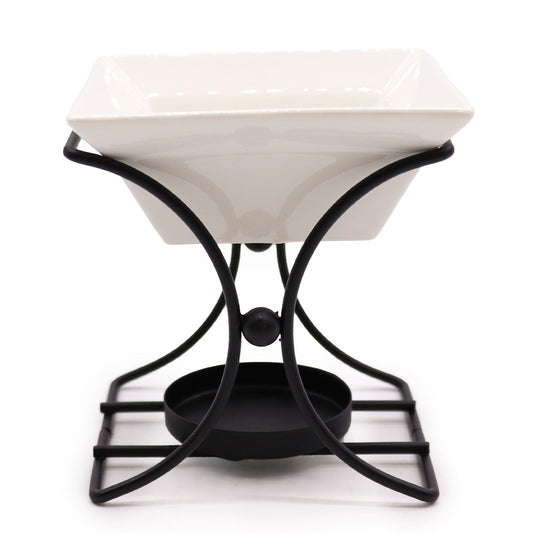 Modern square oil burner featuring a minimalist metal stand and a white ceramic bowl for essential oils.