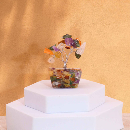Small handmade gemstone tree with multicoloured crystal leaves and a translucent orgonite pyramid base.