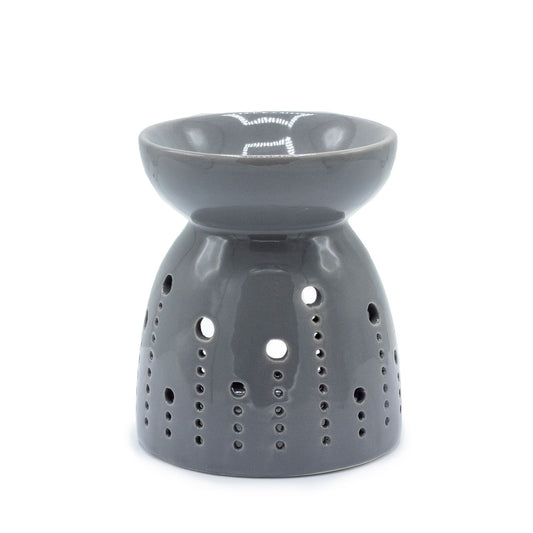 Minimalist grey ceramic oil burner with decorative circular bubble cutouts and a deep well for fragrance oils.