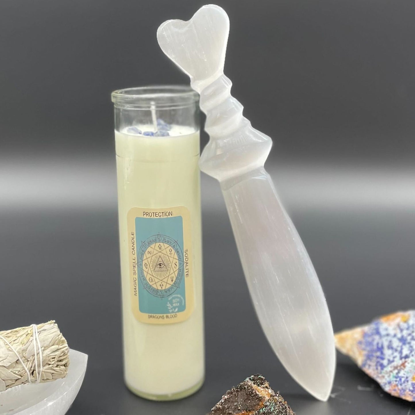 Large hand-carved selenite ritual knife featuring a decorative spiral handle and a smooth, pointed translucent blade.