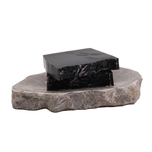 Hand-crafted dark soap bar with a natural texture and artisanal finish.