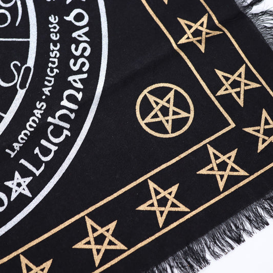 Black fabric altar cloth with white esoteric circular design representing life, death, and rebirth with fringed edges.