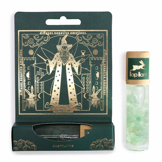 Glass roller bottle with green aventurine gemstones and botanical essential oil blend for tarot-inspired wellness.
