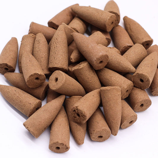 Hexagonal box of sage scented masala backflow incense cones beside a single brown cone.
