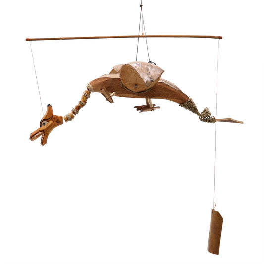 Hand-crafted dragon mobile made from natural coconut shells with a wide wingspan hanging from a hook.