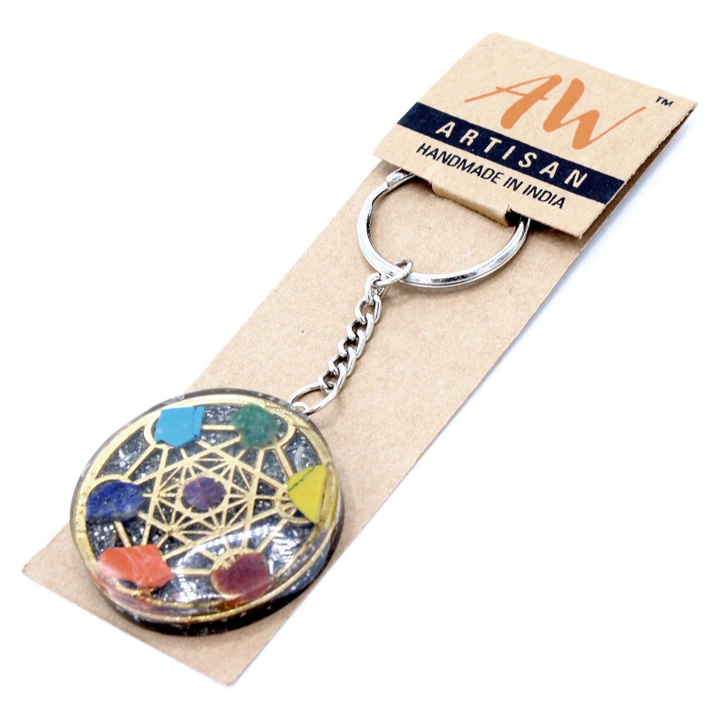 Circular orgonite keyring featuring seven layered chakra stones and copper shavings set in clear resin.